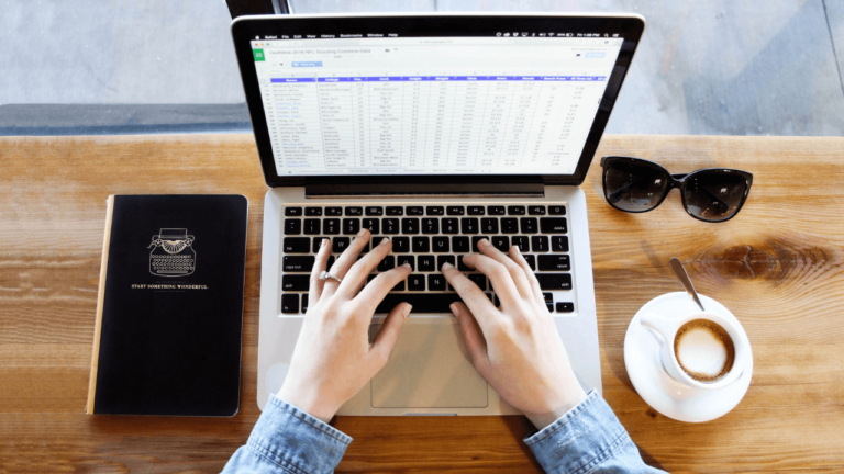 Person on a laptop creating a spreadsheet